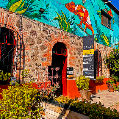 Colorful mural and entrance at Fábrica La Aurora arts complex