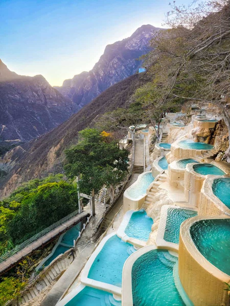 Turquoise thermal pools terraced in a canyon